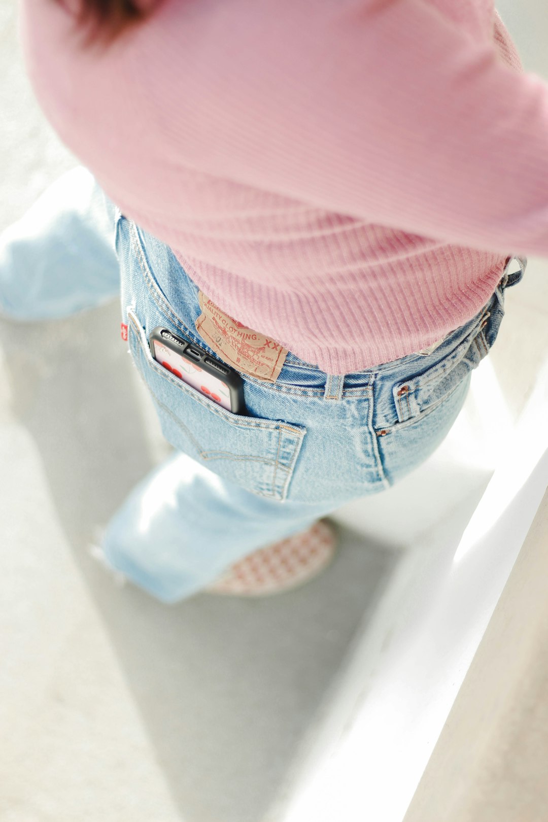 person in blue denim jeans and pink shirt