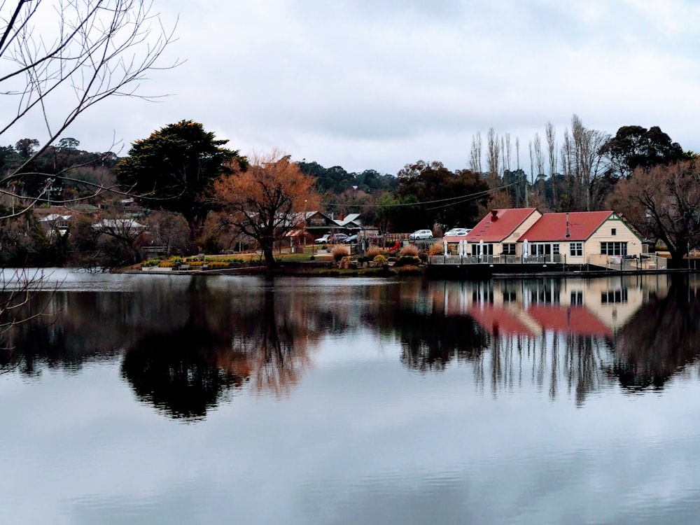 brown and white house near body of water during daytime