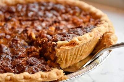 A pecan pie on a white ceramic plate