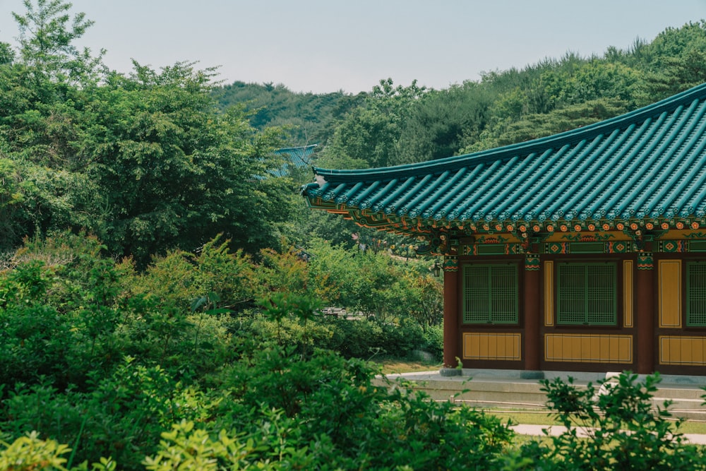 brown and white wooden house surrounded by green trees during daytime