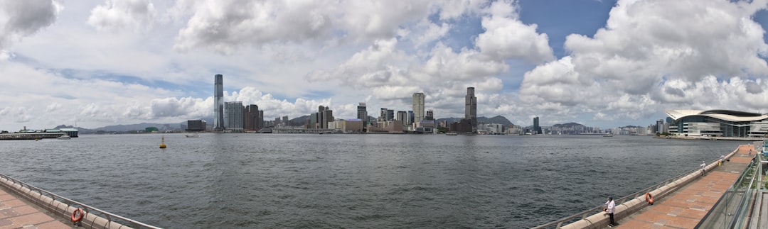 city skyline across body of water under cloudy sky during daytime