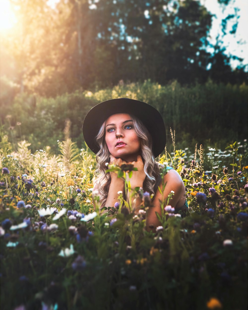 girl in yellow dress standing on flower field during daytime