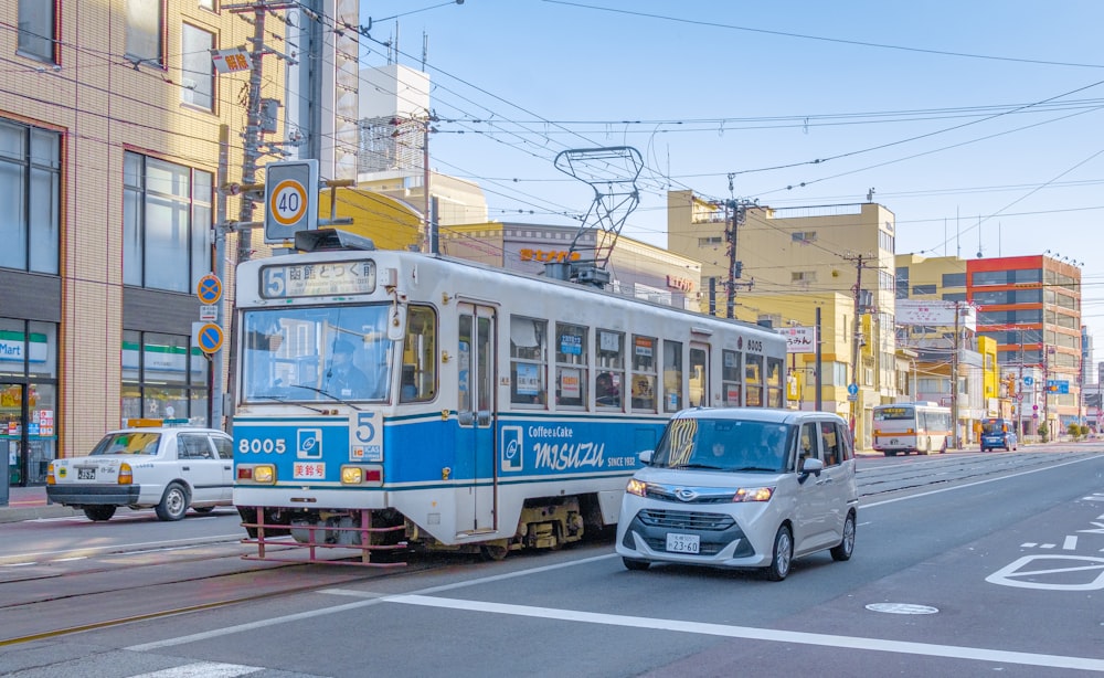 white and yellow tram on road during daytime