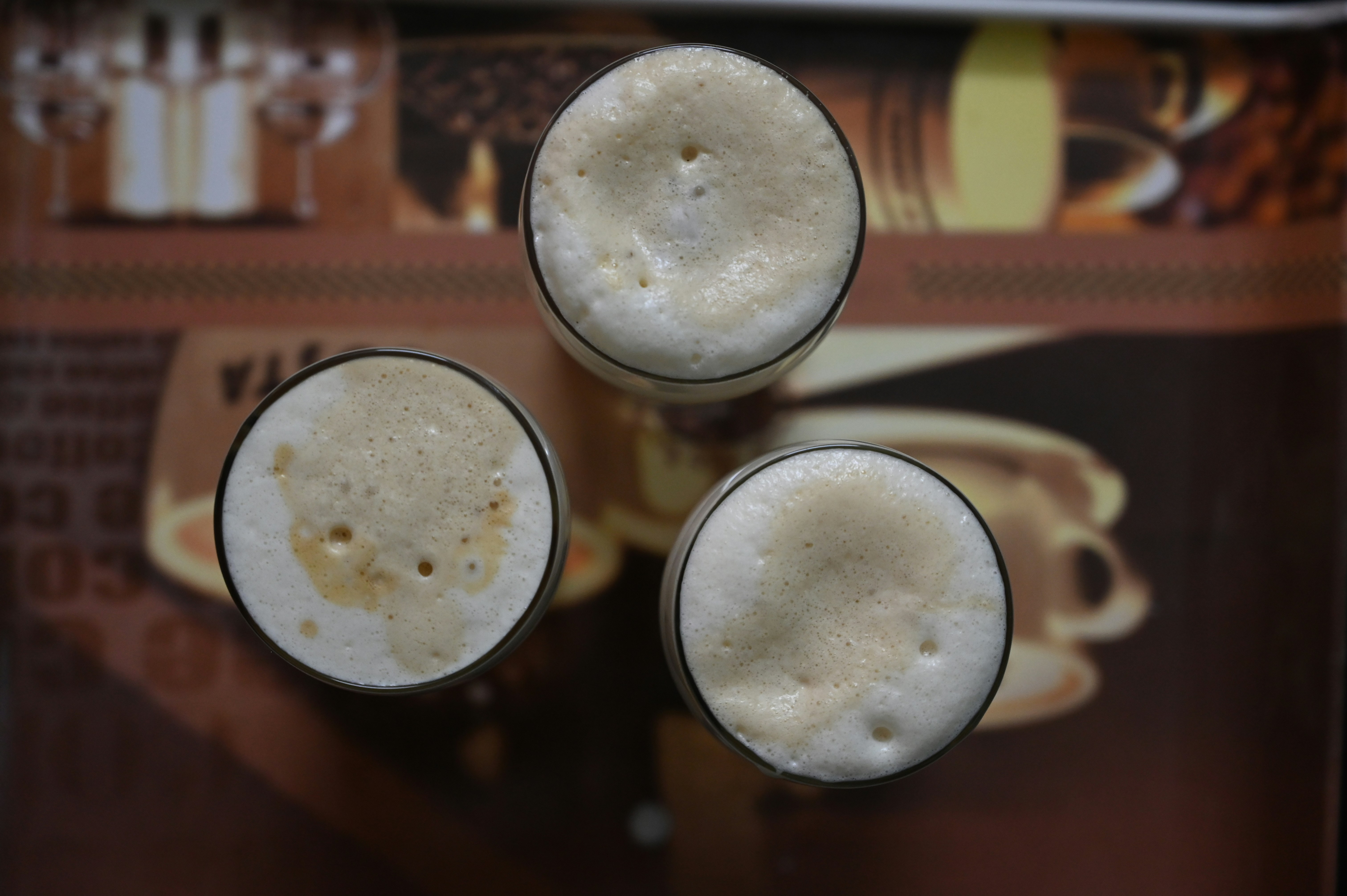 Three glasses of beer seen from above