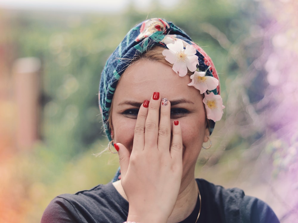 woman in black crew neck shirt with white floral head band