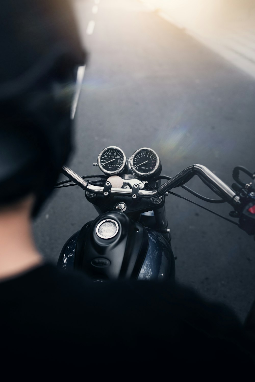 black motorcycle with black helmet