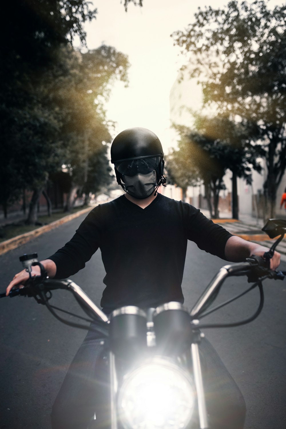 man in black long sleeve shirt riding bicycle during daytime