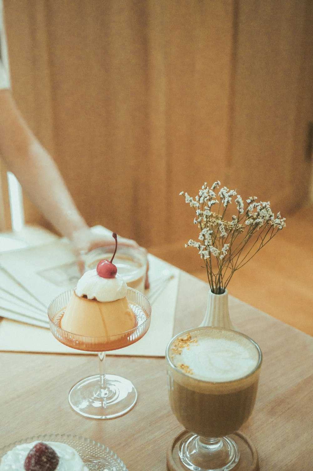 person holding clear glass bowl with ice cream