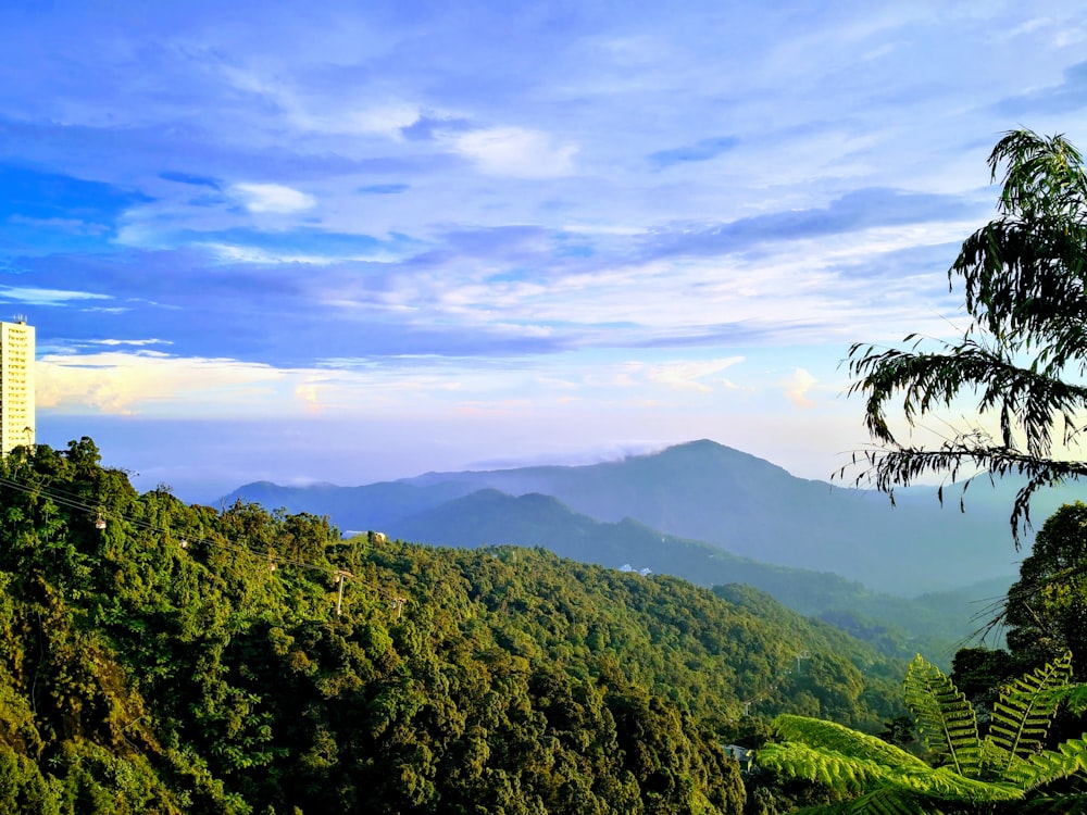 green mountains under white clouds during daytime