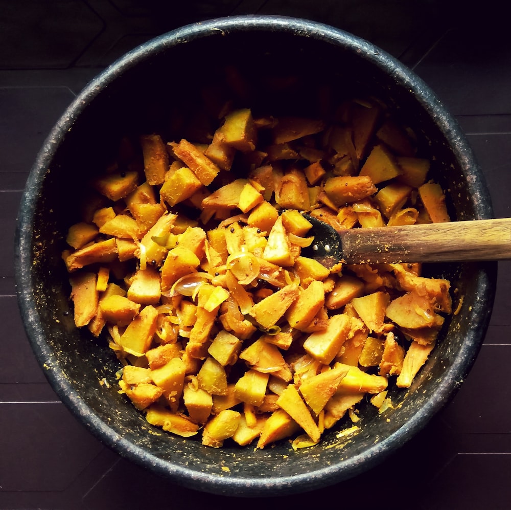 sliced fruit in black ceramic bowl