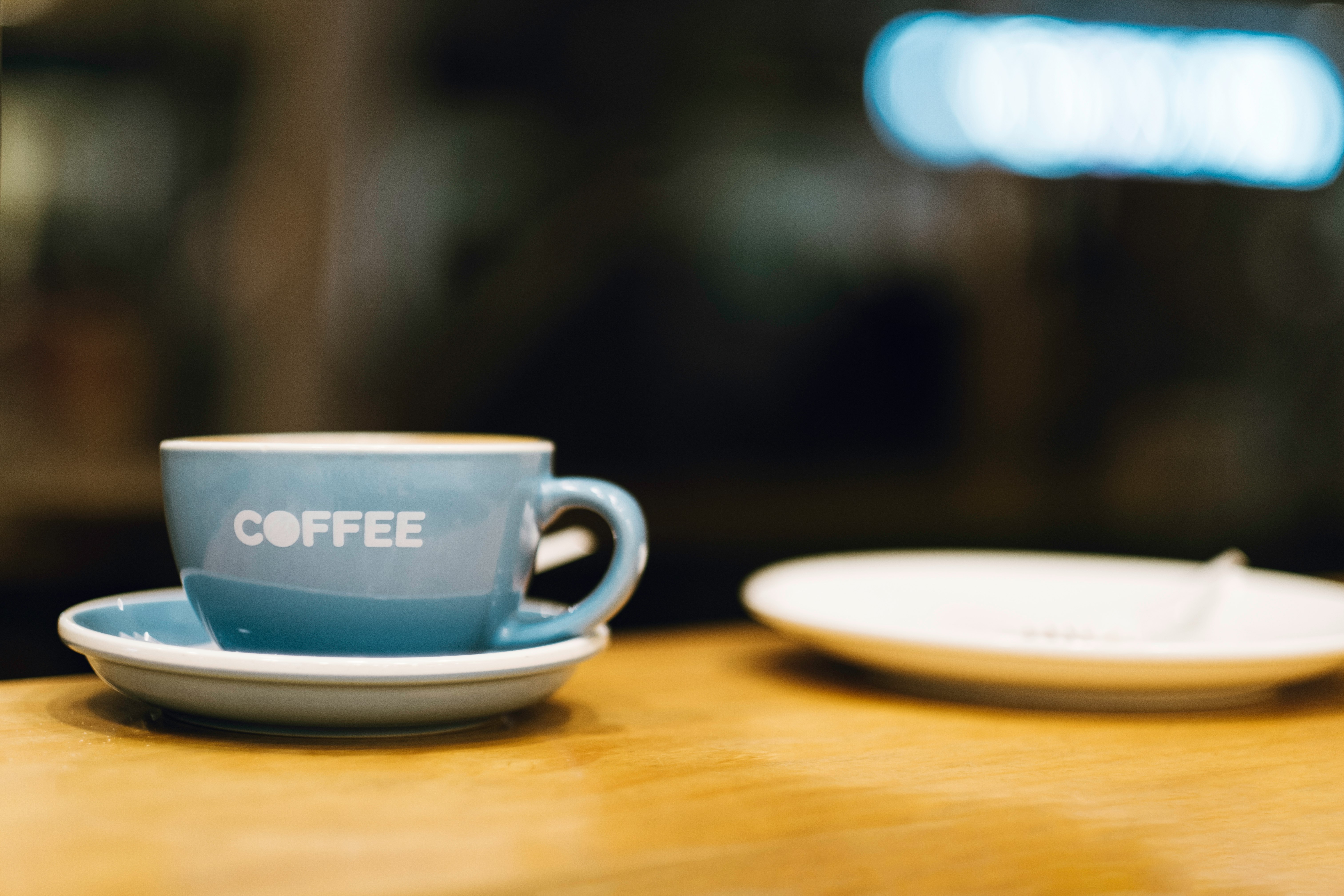 blue ceramic mug on brown wooden table