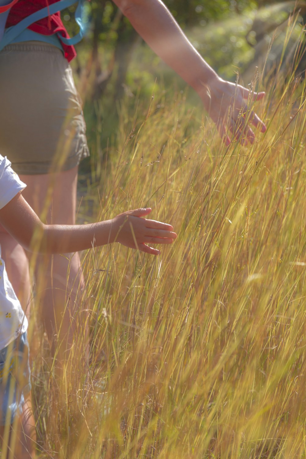 woman in white dress holding hands with man in brown t-shirt