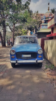 The car parked near a famous Odisha temple under a bright blue sky.