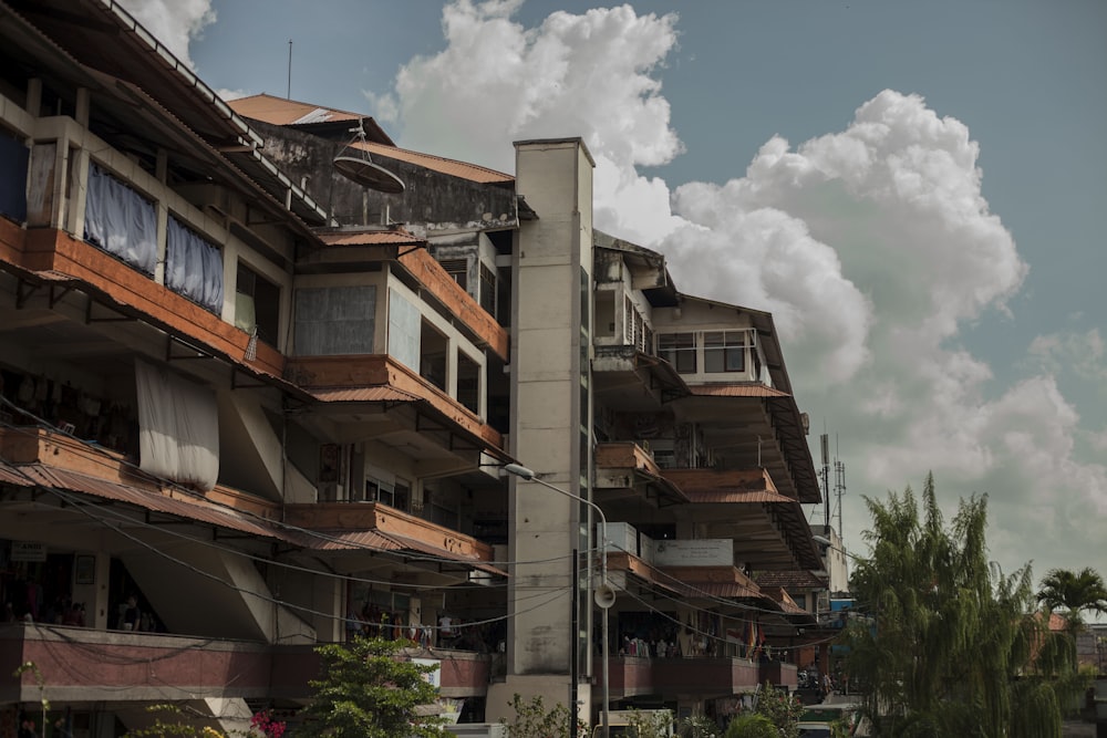 brown and white concrete building under white clouds during daytime