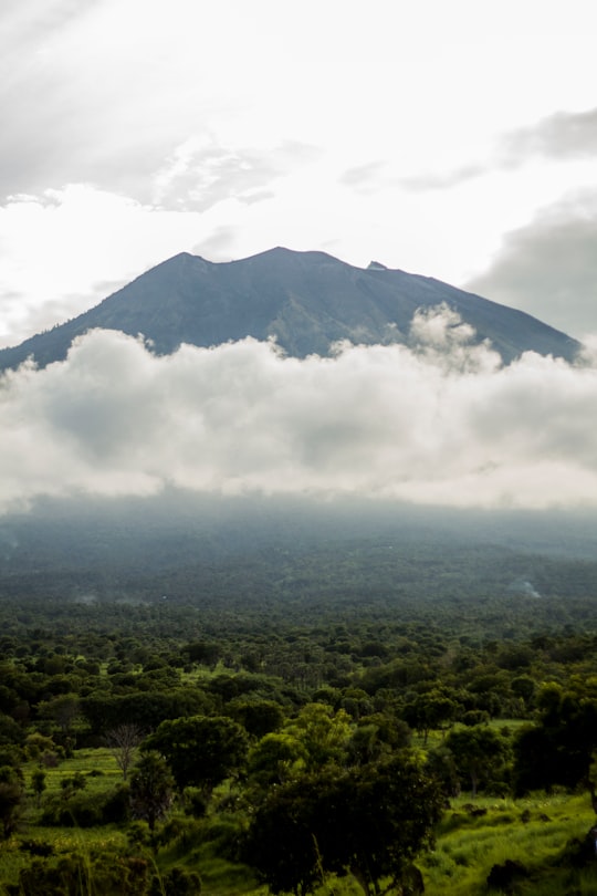 green mountain under white clouds during daytime in Mount Agung Indonesia