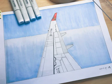 Close-up of a plane blueprint with delicate shading and fine pen strokes on textured paper.