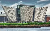 gray concrete building near river during daytime