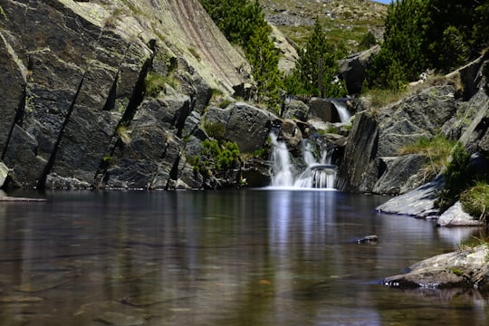 water falls on rocky mountain in Etang de Lanoux France