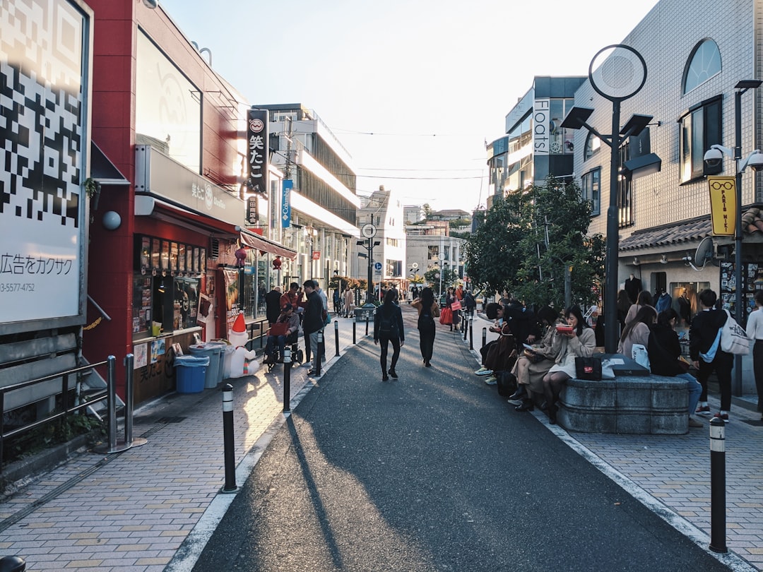 people walking on sidewalk near buildings during daytime