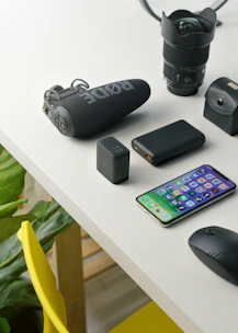 black and gray logitech cordless mouse beside black samsung android smartphone