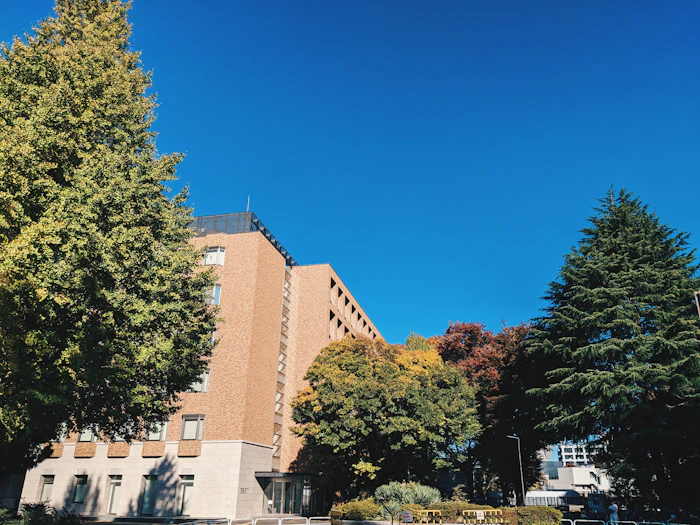 University campus building among green trees