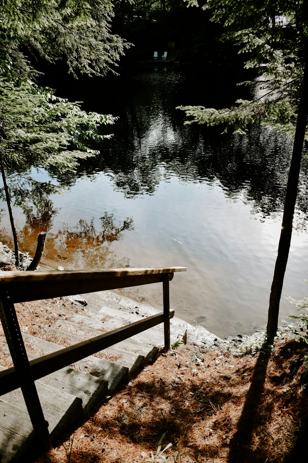 brown wooden fence near lake during daytime