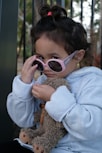 woman in gray sweater wearing brown sunglasses