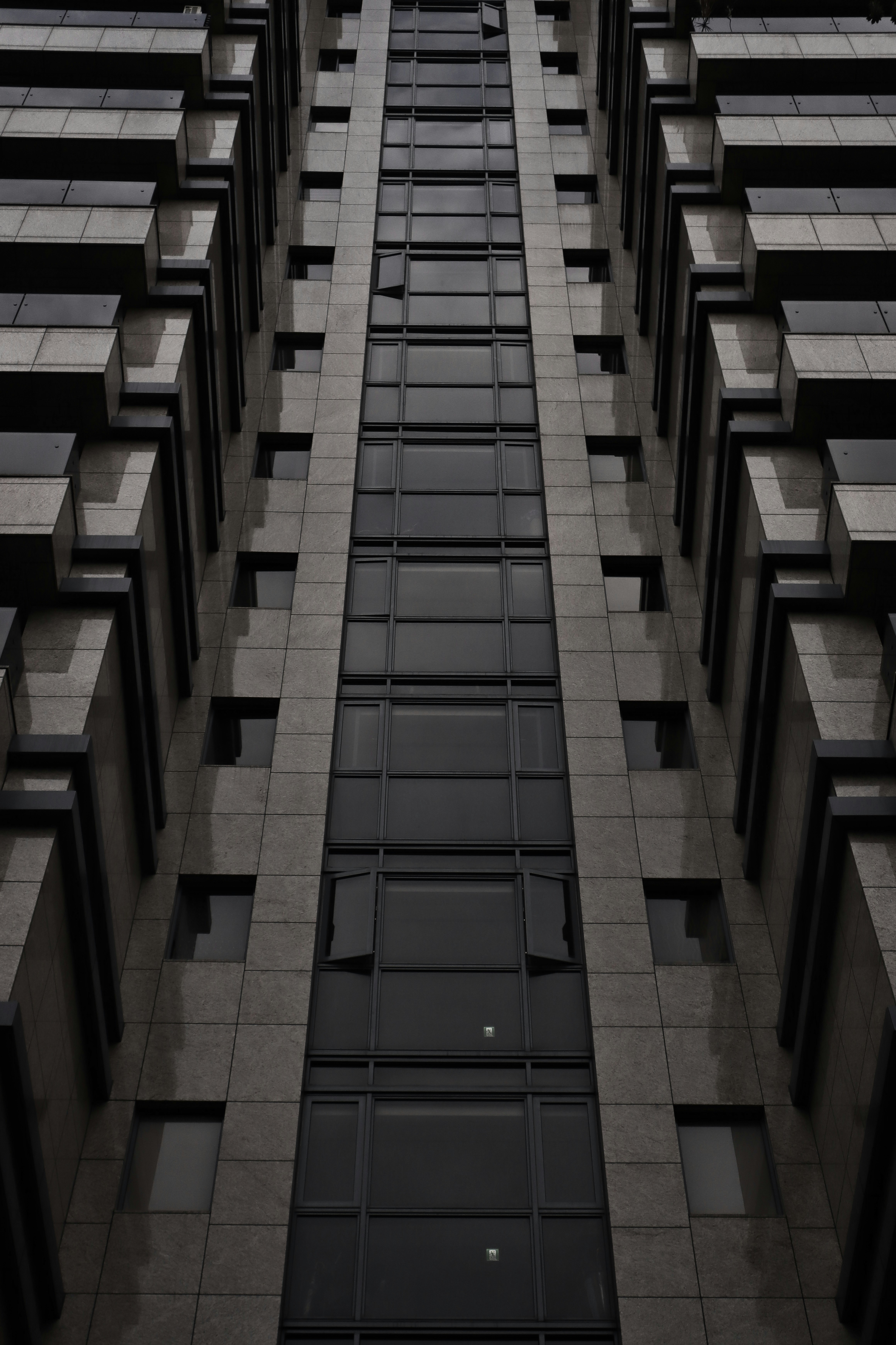 Modern brick commercial building exterior at slight angle showing façade texture, natural daylight, architectural photography style