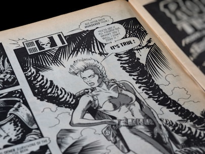 A comic book panel featuring a fierce-looking female character with short hair, wearing a form-fitting outfit and a leather belt. The background includes stylized palm fronds and a cloudy sky. The panel contains speech bubbles indicating a conversation about a murder and a revelation.