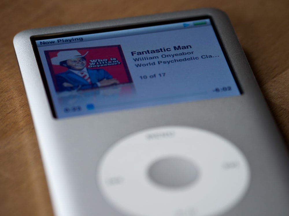 white ipod classic on brown wooden table