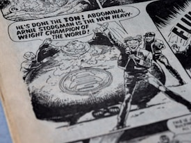 A comic book illustration featuring a confident announcer declaring Arnie Stodgman as the new heavyweight champion of the world. The image includes an oversized character with a large abdomen, surrounded by cheering figures. The style is classic black and white, with bold text and dynamic expressions.