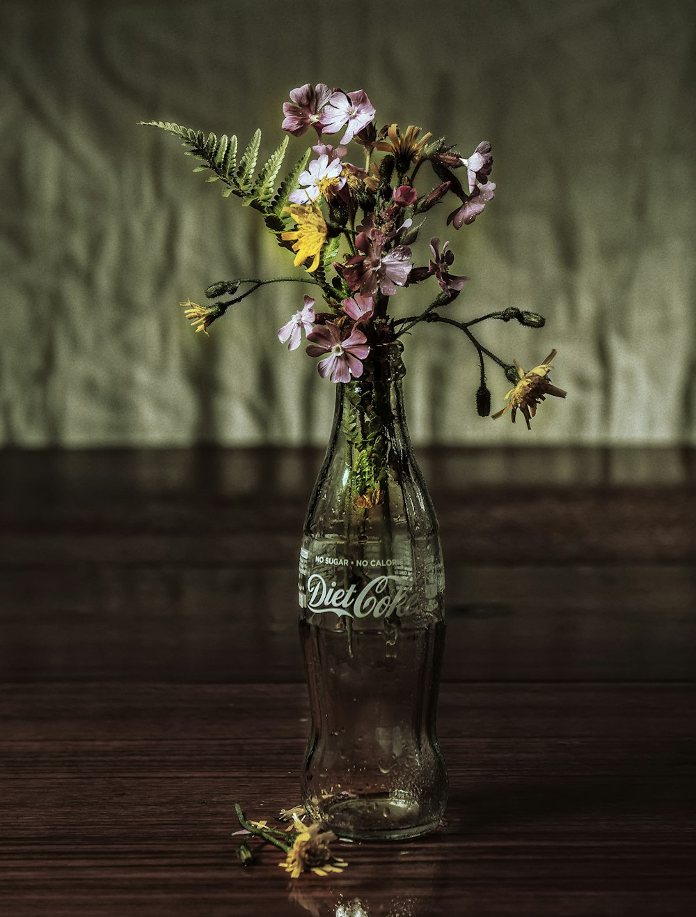 purple and white flowers in clear glass vase