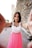 woman in white and pink sleeveless dress smiling