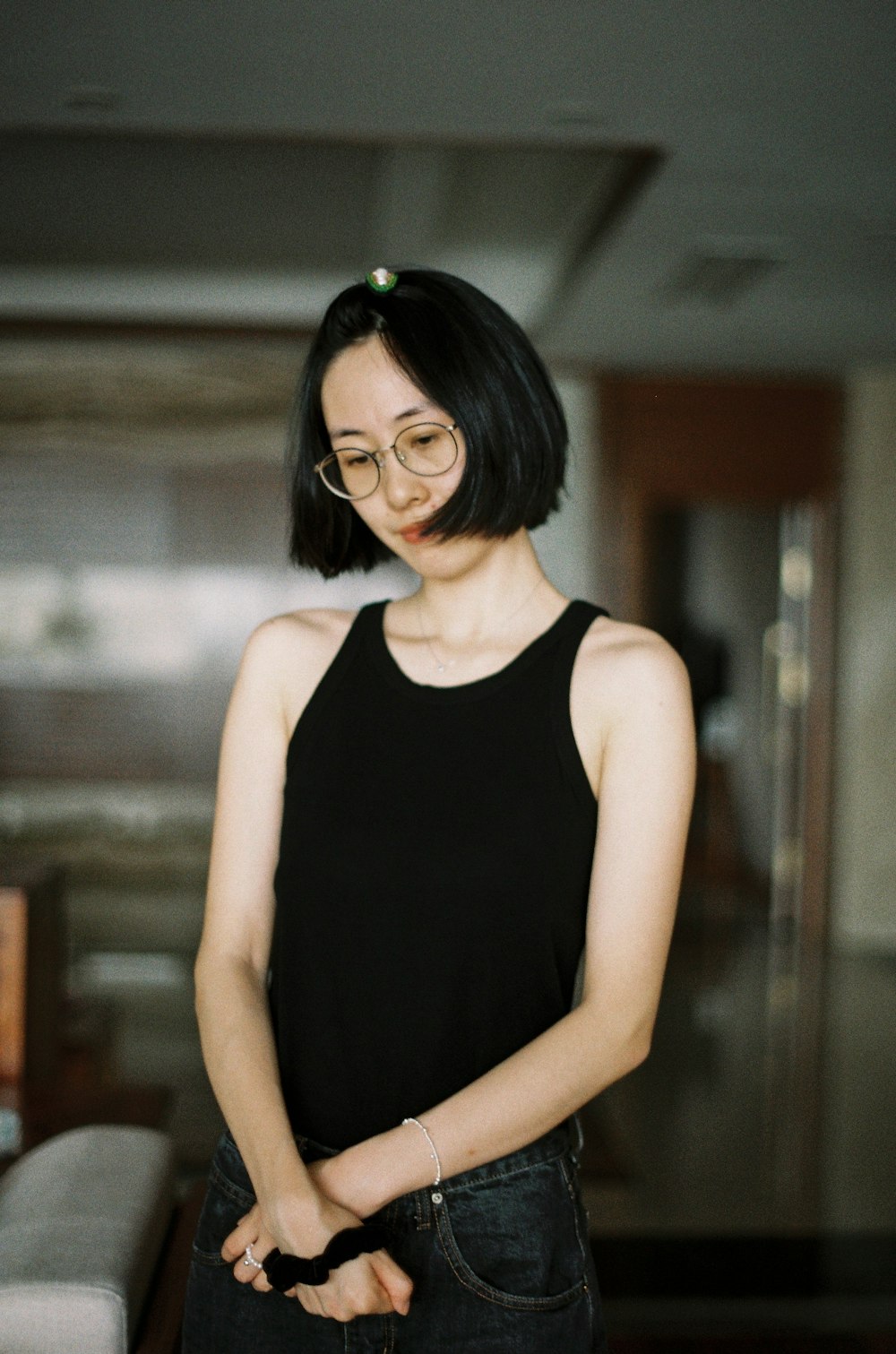 woman in black tank top wearing black framed eyeglasses