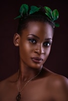 woman with green and white flower on ear
