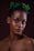 woman with green and white flower on ear