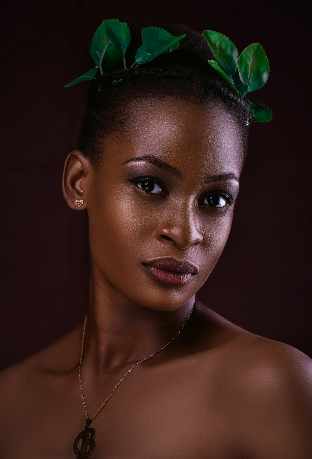 woman with green and white flower on ear