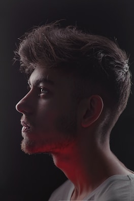 Side profile highlighting receding hairline on a serene background.