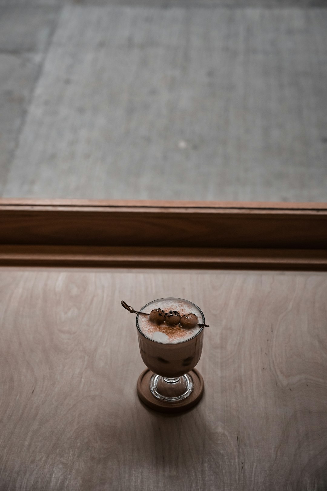 ice cream in clear glass cup on brown wooden table