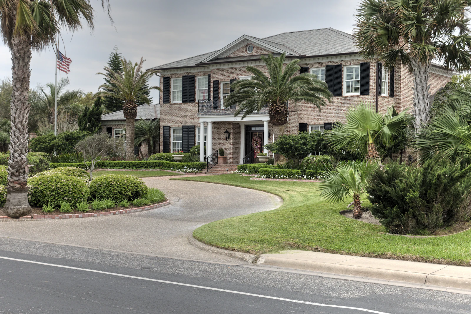 A two-story house with a landscaped front bed.