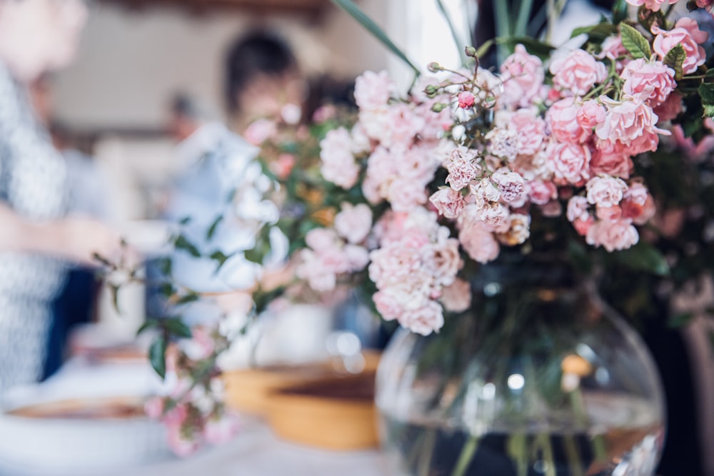 pink and white flowers in clear glass vase