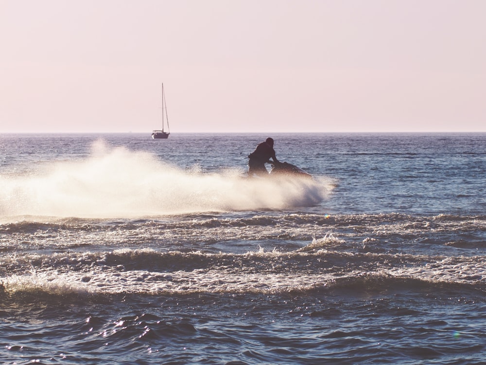 man surfing on sea waves during daytime