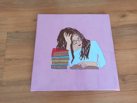Portrait of Minah Kang deep in thought, surrounded by books.