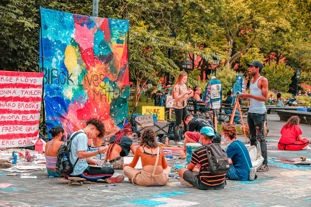 people sitting on blue and red outdoor lounge chair during daytime