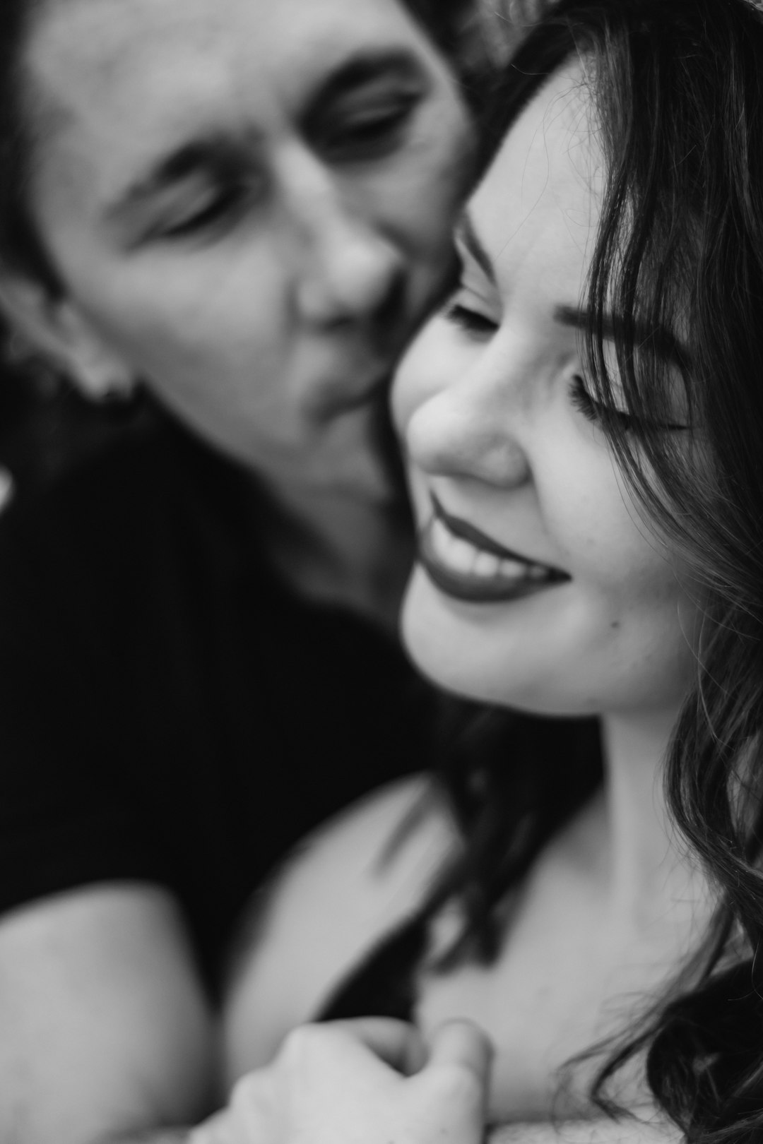 grayscale photo of man and woman smiling