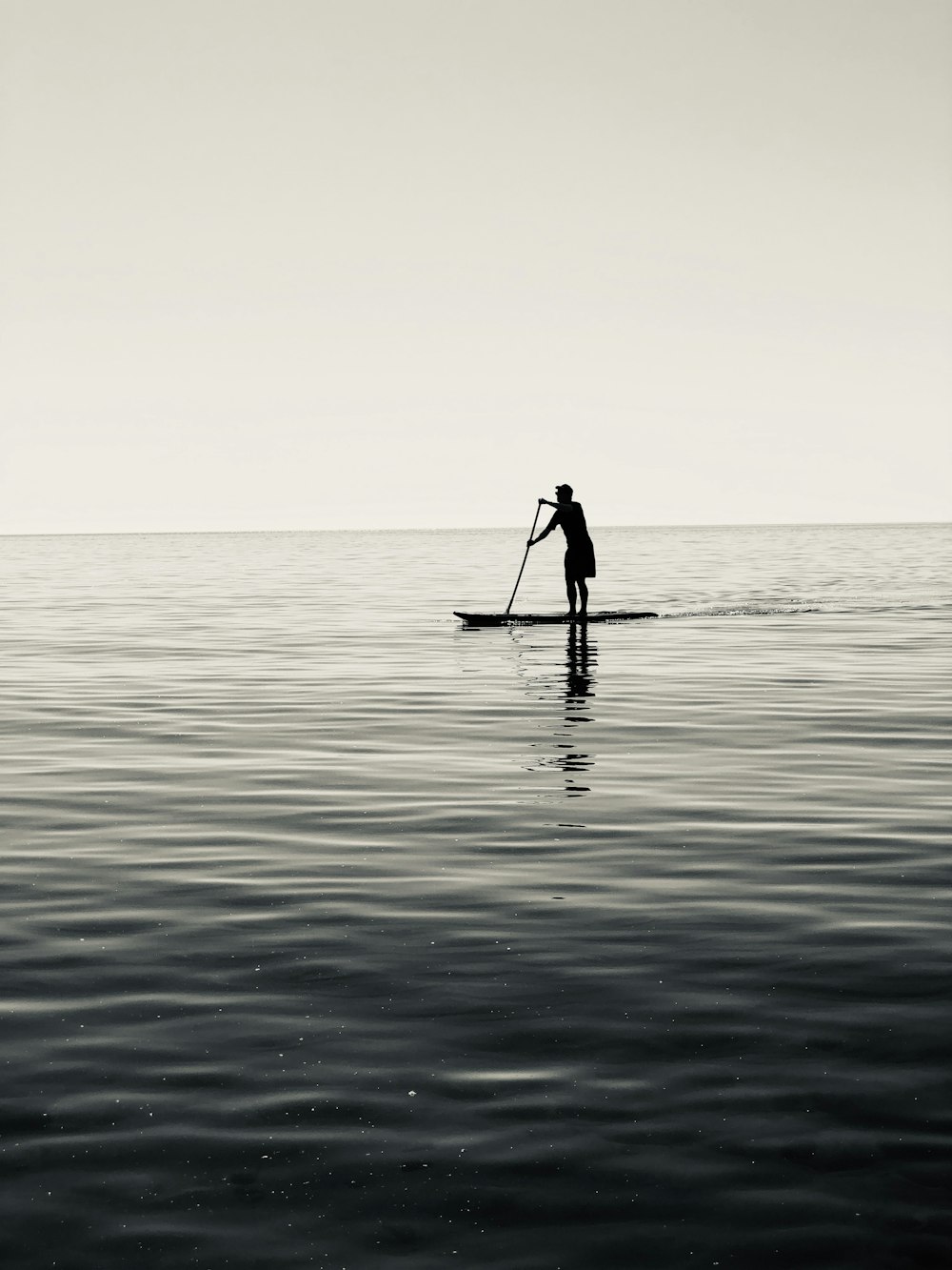 silhouette of person riding on boat on sea during daytime