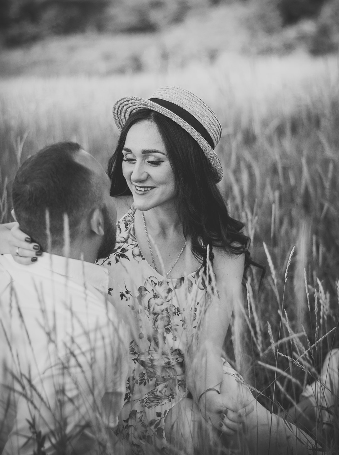 woman in white and black hat kissing man in black and white hat