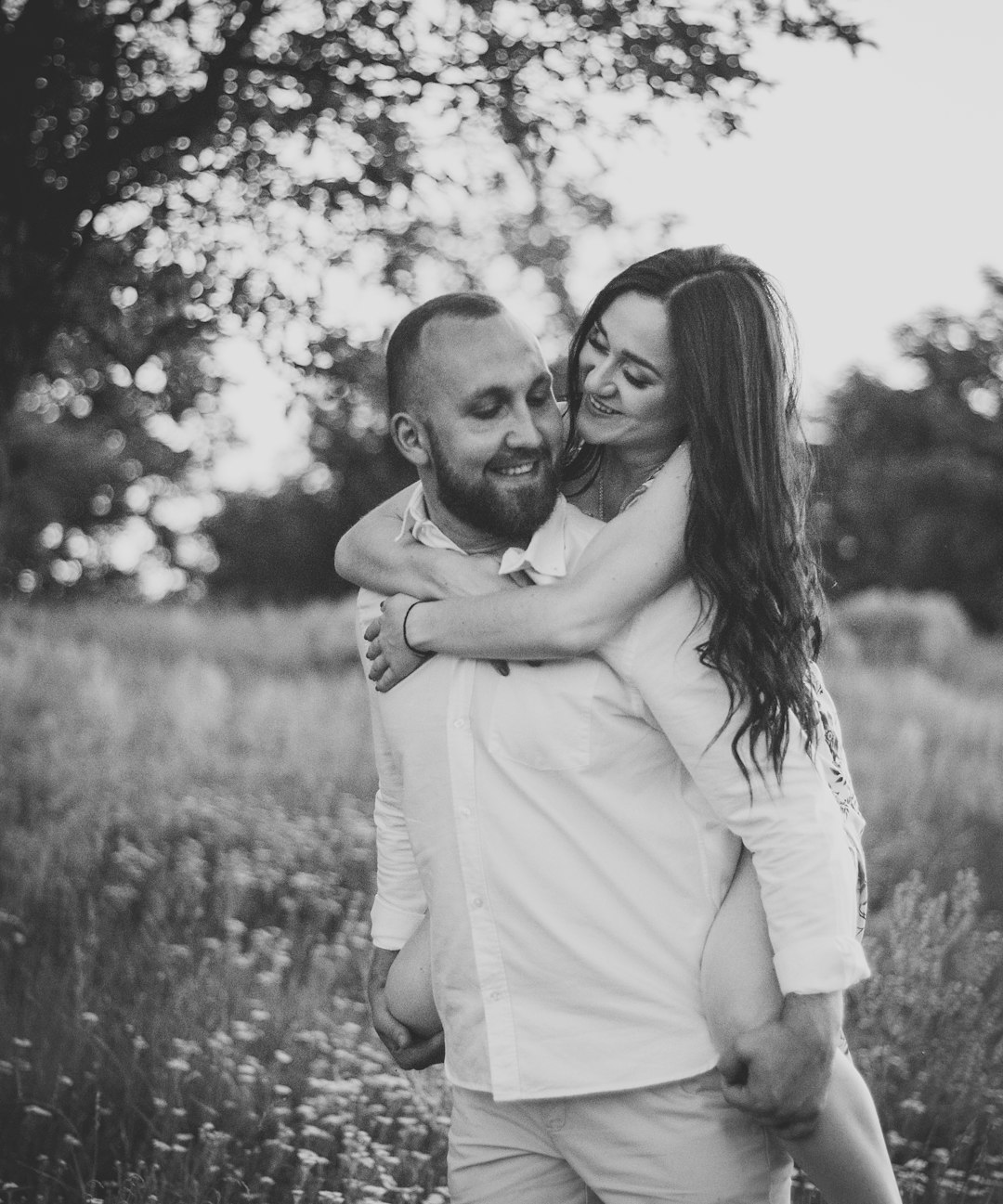 grayscale photo of man kissing womans cheek