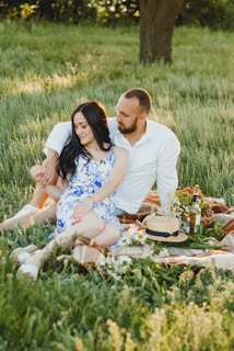 A scenic outdoor shot of individuals enjoying a picnic while dressed in chic summer attire.
