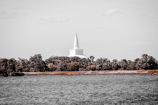 A serene temple surrounded by lush greenery and trees.